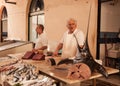Fishmonger selling swordfish in an old local market