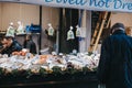 Fishmonger stall in Borough Market, London, UK, man looking at the selection of fish on sale