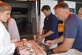 Fishmongers prepare and shuck oysters for the visitors at the Whitstable Oyster Festival Royalty Free Stock Photo