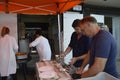 Fishmongers prepare and shuck oysters for the visitors at the Whitstable Oyster Festival