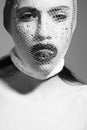 Fishnet stocking on head of girl showing tongue, black lips Royalty Free Stock Photo
