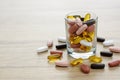 Fishoil capsules and Multivitamin supplements in the small glass Royalty Free Stock Photo