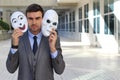 Fishy businessman holding scary masks isolated Royalty Free Stock Photo