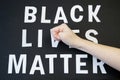 fist beats on words black lives matter on black background Royalty Free Stock Photo