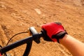 Fist of a boy with red cyclist gloves pedaling on a dirt track Royalty Free Stock Photo