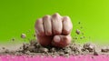 Fist breaking through dirt against a green background. Royalty Free Stock Photo