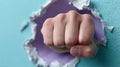 Fist breaking through paper wall, symbolizing strength and power. Royalty Free Stock Photo