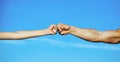 Fist Bump. Clash of two fists, vs. Concept of confrontation, competition. Gesture of giving respect or approval. Friends