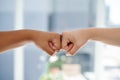 Fist bump, worker hands and motivation gesture of success, support and trust in a office. Friends, team building and