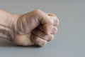 fist on gray background. The concept of domestic violence. Male rudeness and violence