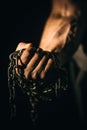 Fist hand holds the chain. Concept fitness, lifting, fitness.