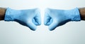 A fist in a medical glove. Doctor`s hand in a blue medical glove on a light background Royalty Free Stock Photo