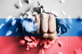 A fist punches through a concrete wall with the colors of the Russian flag Royalty Free Stock Photo