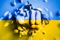 A fist punches through a concrete wall with the colors of the Ukrainian flag Royalty Free Stock Photo