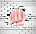 Fist Punching Through White Brick Wall Royalty Free Stock Photo