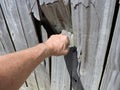 Fist punching through wooden fence
