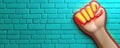 Fist Reaching Forward Against Bright Turquoise Brick Wall Background Royalty Free Stock Photo