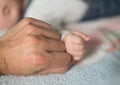 Fist of a small child. Fist of Dad and Newborn Baby. Fist to fist Royalty Free Stock Photo