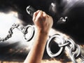 Fist smashes the fetters. Chains in the form of procent sign. Concept freedom from the chains of slavery Royalty Free Stock Photo