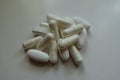 Fistful of capsules of magnesium citrate and caplets of calcium citrate Royalty Free Stock Photo