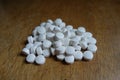 Fistful of small white xylitol tablets