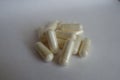 Fistful of white capsules of Acetyl L-Carnitine