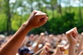 Fists from many people are raised at a protest