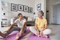 Fit active mature wife and senior husband having fun exercising at home. Royalty Free Stock Photo