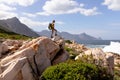 Fit afrcan american woman wearing backpack hiking on the coast Royalty Free Stock Photo