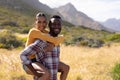 Fit african american couple resting and embracing in mountain countryside Royalty Free Stock Photo