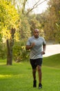 Mature fit African American man running outside. Royalty Free Stock Photo