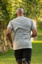 Mature fit African American man running outside. Royalty Free Stock Photo