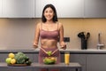 Fit Asian Lady Cooking Salad In Kitchen, Smiling To Camera