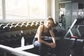 Fit asian woman sitting and relax after the training session in gym,Concept healthy and lifestyle,Female taking a break after exer Royalty Free Stock Photo