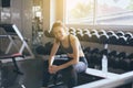 Fit asian woman sitting and relax after the training session in gym,Concept healthy and lifestyle,Female taking a break after exer Royalty Free Stock Photo