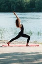 Fit female practice yoga exercise in the open Royalty Free Stock Photo