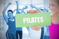 Fit blonde holding card saying pilates