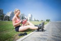 Fit blonde putting on her roller blades Royalty Free Stock Photo