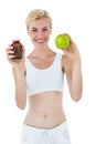 Fit blonde woman holding medicine and green apple Royalty Free Stock Photo