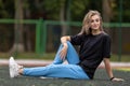 Fit blonde woman in oversized clothes posing outdoor Royalty Free Stock Photo