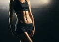 Fit body of beautiful, healthy and sporty girl. Slim woman posing in sportswear. Royalty Free Stock Photo