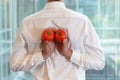 Fit business man with tomatoes as a healhy snack