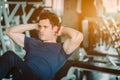 Fit caucasian handsome man sit up on machine in sportswear. Young man sit up exercise to strength their core abdominal muscles at Royalty Free Stock Photo