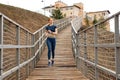 Fit redhead caucasian male in sportswear jobbing in bridge in countryside alone