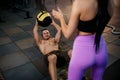 Fit caucasian man doing abdominal ball exercise with personal trainer in the gym. Royalty Free Stock Photo