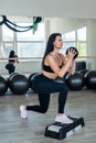 Fit caucasian young woman in sportswear doing step aerobics exercise at fitness studio Royalty Free Stock Photo