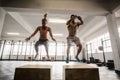 Fit couple doing set of box jumps Royalty Free Stock Photo