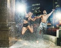 Fit couple jumping in the fountain Royalty Free Stock Photo