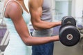 Fit couple lifting dumbbells together