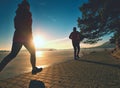 Fit couple, man and woman running along waterfront